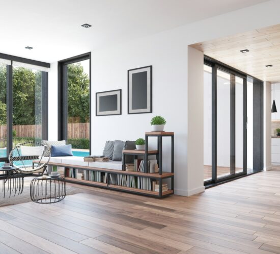 Modern living space with large windows, a pool view, wooden floors, and stylish furniture.